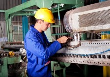 12431999 - industrial mechanic repairing heavy industry machine in plant