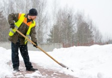18238913 - man worker in uniform shoveling snow
