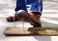 Worker steps on nail outdoors